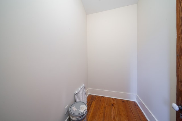 laundry area with wood-type flooring