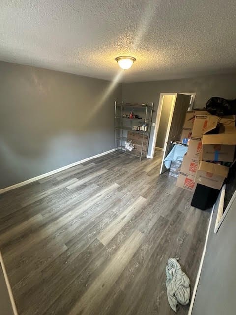 3019 50th St, Valley, AL 36854 - unfurnished bedroom featuring a textured ceiling and wood finished floors