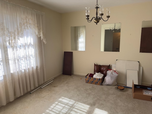 carpeted dining area with a chandelier