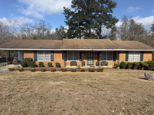 single story home featuring a front lawn and a carport