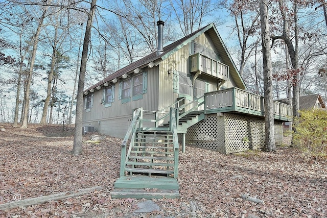 rear view of property with a wooden deck and central AC