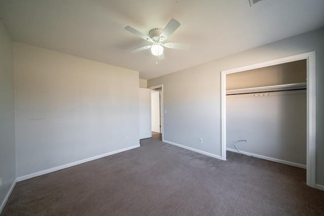 unfurnished bedroom featuring ceiling fan, a closet, and dark colored carpet