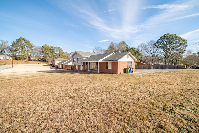 view of side of home featuring a yard