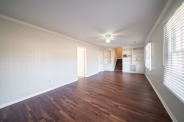 interior space featuring crown molding, ceiling fan, dark hardwood / wood-style flooring, and built in features