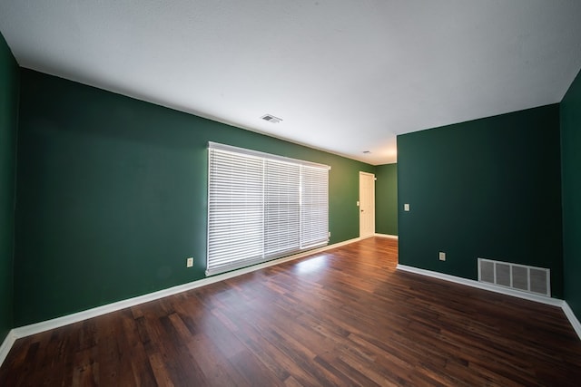 empty room with dark wood-type flooring