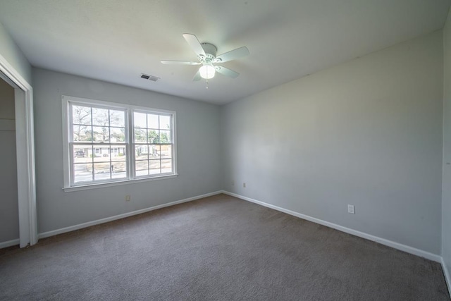 carpeted spare room with ceiling fan