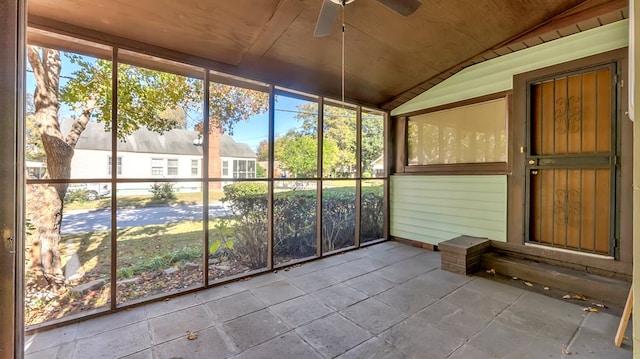 unfurnished sunroom with a healthy amount of sunlight, vaulted ceiling, wooden ceiling, and ceiling fan