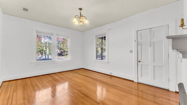 interior space with an inviting chandelier and hardwood / wood-style floors