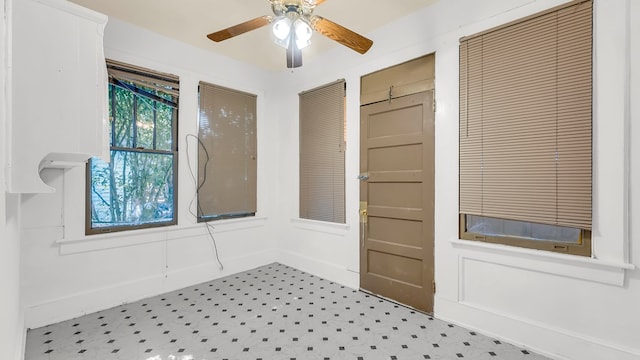 interior space with ceiling fan