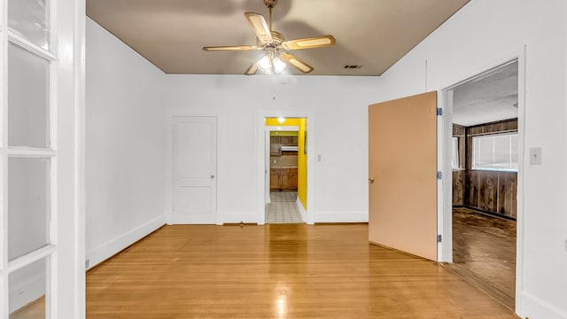 unfurnished bedroom featuring ceiling fan and light hardwood / wood-style floors