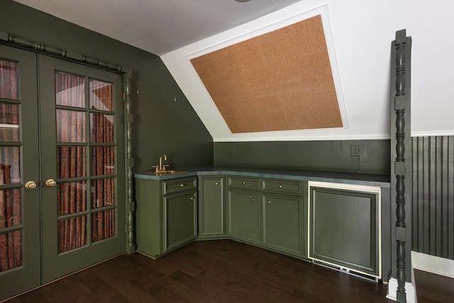 bar with lofted ceiling, french doors, a sink, and dark wood finished floors