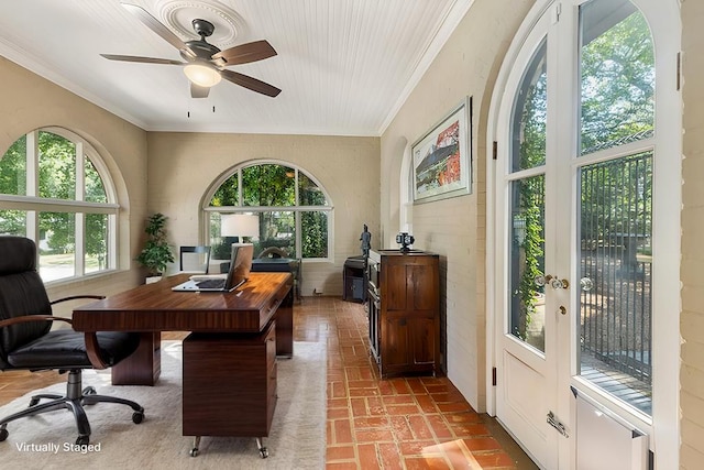 office space with brick floor, crown molding, and ceiling fan