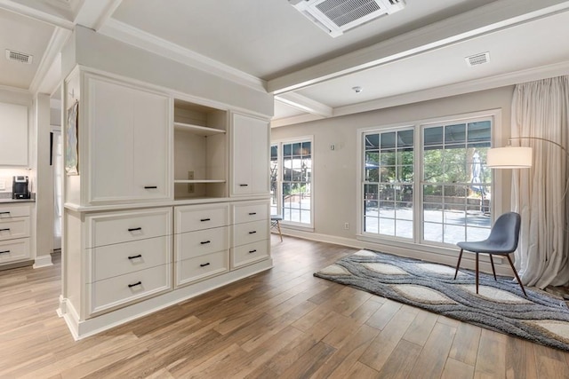 living area featuring light wood-style floors, beam ceiling, visible vents, and ornamental molding