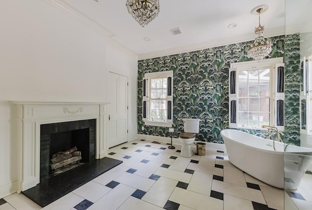 interior space featuring wallpapered walls, ornamental molding, a freestanding bath, and an inviting chandelier