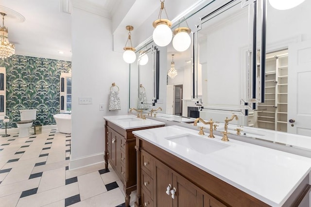 bathroom with a soaking tub, ornamental molding, a sink, baseboards, and wallpapered walls