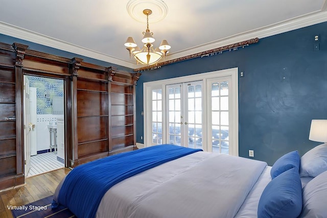 bedroom with french doors, crown molding, an inviting chandelier, wood finished floors, and access to outside