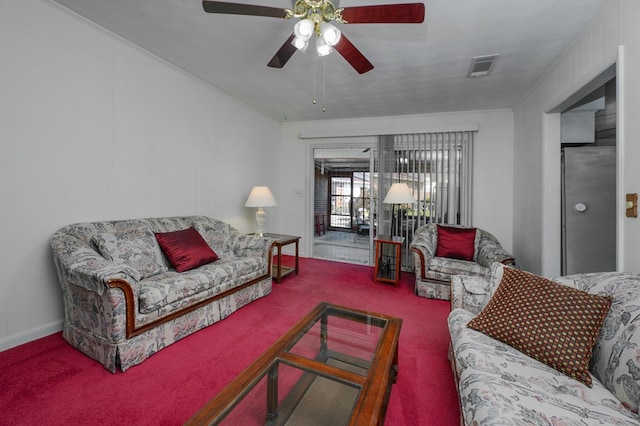 carpeted living room with ceiling fan, visible vents, and crown molding