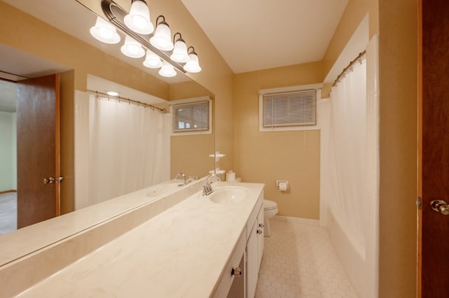 full bath with toilet, tile patterned flooring, baseboards, and vanity