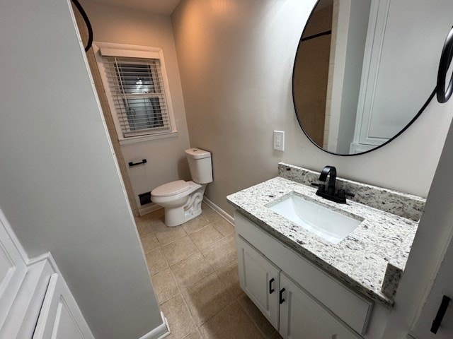 bathroom with vanity, tile patterned floors, toilet, and baseboards