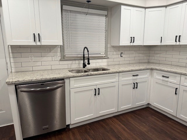 kitchen featuring dishwasher, white cabinets, dark wood finished floors, and a sink