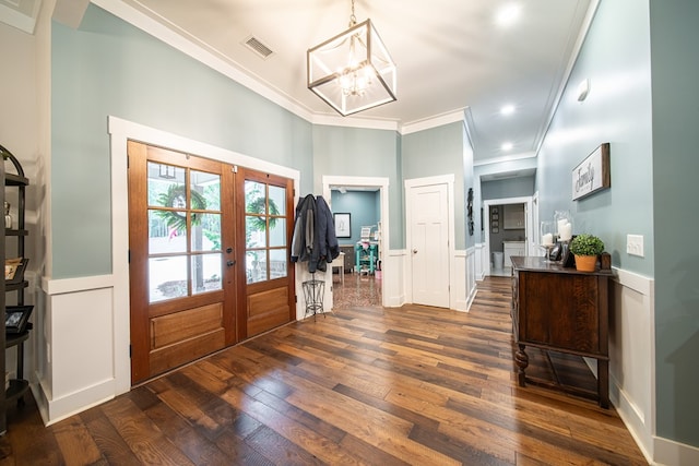 11602 Ga Highway 0085, Waverly Hall, GA 31831 - entrance foyer with french doors, ornamental molding, dark wood-style flooring, a chandelier, and a decorative wall
