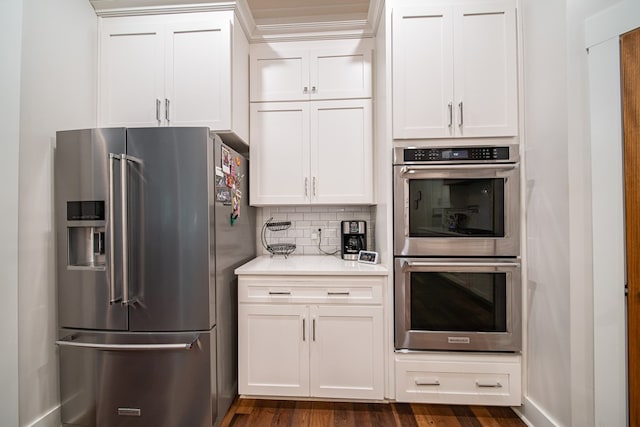 11602 Ga Highway 0085, Waverly Hall, GA 31831 - kitchen with appliances with stainless steel finishes, light countertops, white cabinetry, backsplash, and dark wood-type flooring