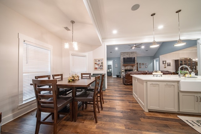 11602 Ga Highway 0085, Waverly Hall, GA 31831 - dining space with a large fireplace, a ceiling fan, baseboards, dark wood-style flooring, and ornamental molding