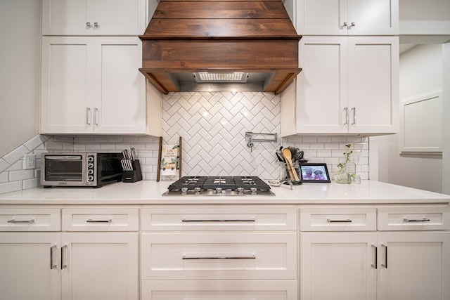 11602 Ga Highway 0085, Waverly Hall, GA 31831 - kitchen featuring stainless steel gas cooktop, custom range hood, backsplash, and white cabinets