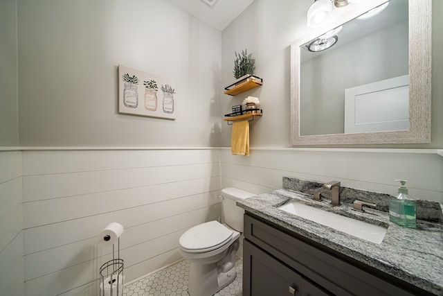 11602 Ga Highway 0085, Waverly Hall, GA 31831 - bathroom featuring toilet, vanity, wainscoting, and tile patterned flooring