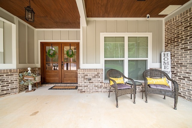 11602 Ga Highway 0085, Waverly Hall, GA 31831 - view of exterior entry with french doors, board and batten siding, and brick siding