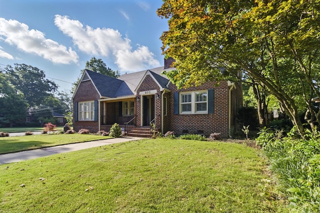 view of front of house with brick siding and a front lawn