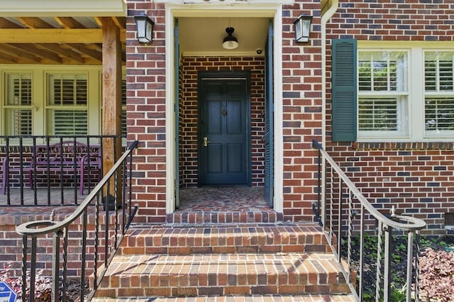 property entrance with brick siding