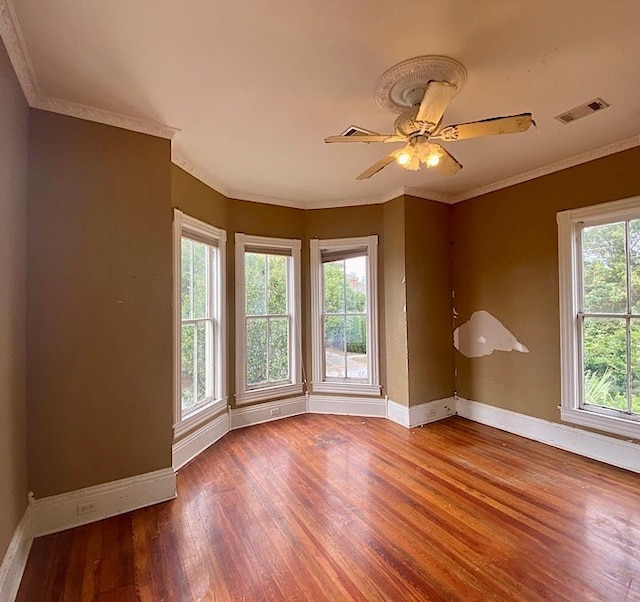 unfurnished room with hardwood / wood-style floors, ceiling fan, and ornamental molding