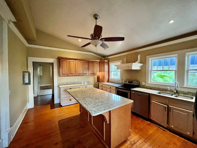 kitchen featuring sink, lofted ceiling, a kitchen bar, a kitchen island, and appliances with stainless steel finishes