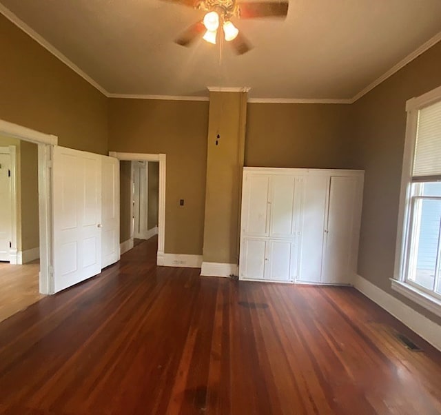 unfurnished bedroom with dark hardwood / wood-style floors, ceiling fan, and crown molding