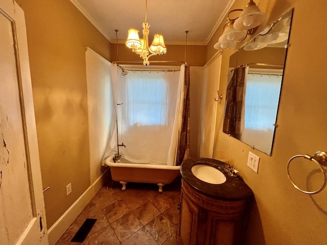bathroom with crown molding, a bathtub, vanity, and a notable chandelier