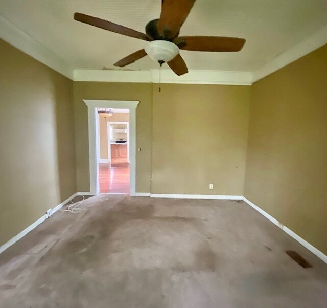 carpeted spare room with ceiling fan
