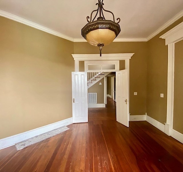empty room with dark hardwood / wood-style floors and ornamental molding