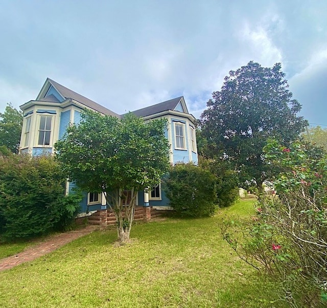 view of property exterior with a lawn