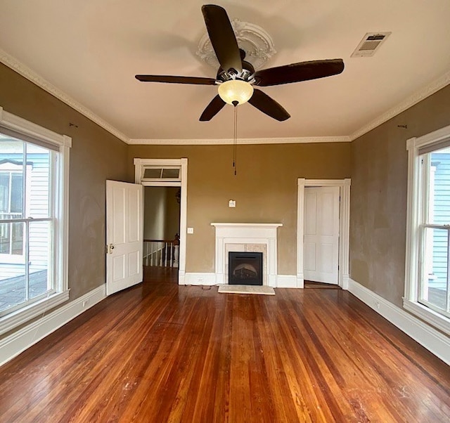 unfurnished living room with ceiling fan, hardwood / wood-style floors, and a healthy amount of sunlight