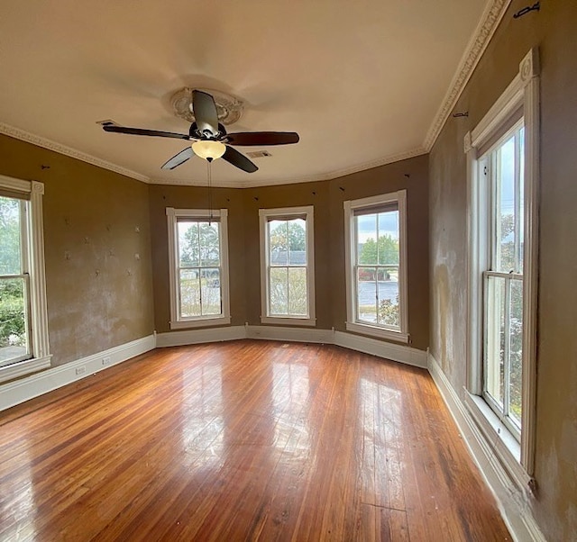unfurnished room with ceiling fan, a healthy amount of sunlight, and light hardwood / wood-style flooring