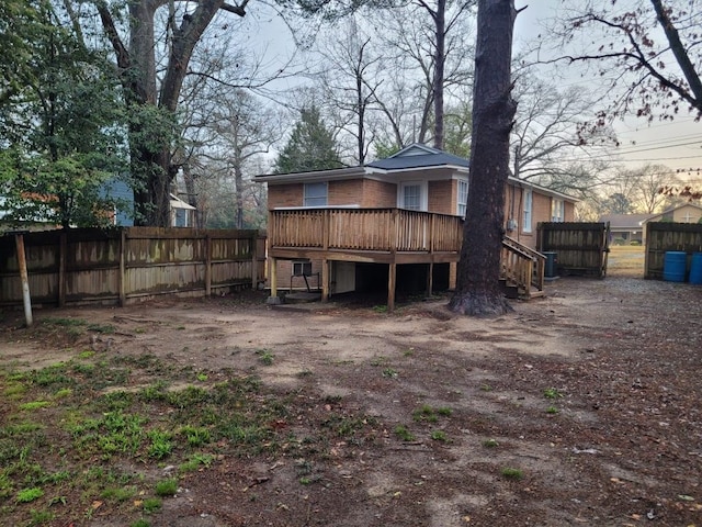 rear view of house with a wooden deck