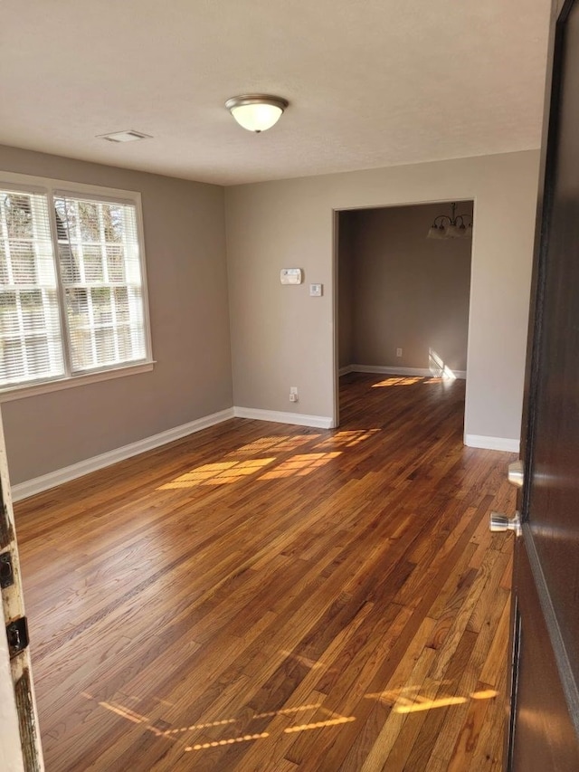 spare room featuring dark hardwood / wood-style flooring