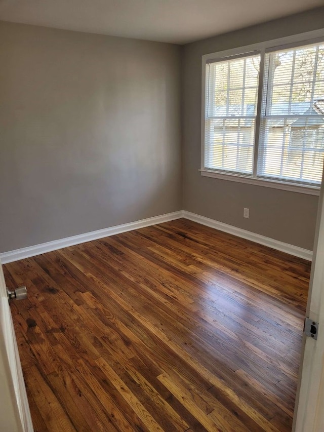 empty room with dark wood-type flooring