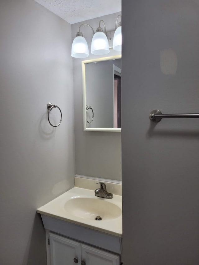 bathroom with vanity and a textured ceiling