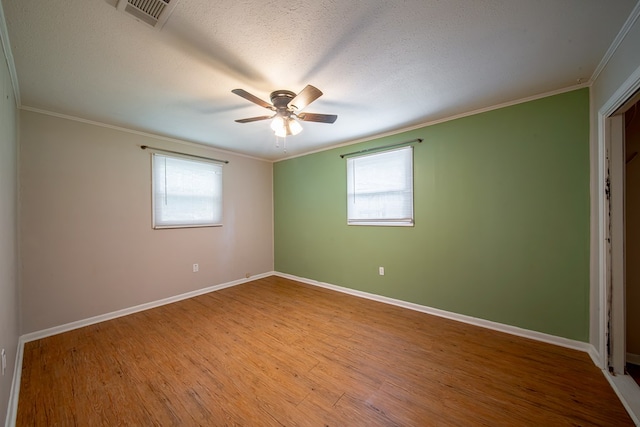 22 Oak Dr, Pine Mountain, GA 31822 - empty room featuring plenty of natural light, ornamental molding, a ceiling fan, wood finished floors, and a textured ceiling