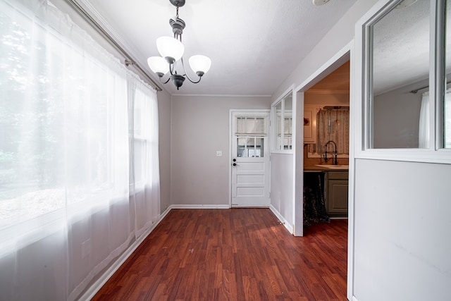 22 Oak Dr, Pine Mountain, GA 31822 - unfurnished dining area featuring a chandelier, healthy amount of natural light, and dark wood-style flooring