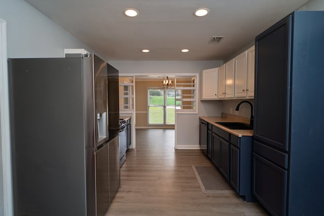 2 Labrador Ct, Columbus, GA 31909 - kitchen with appliances with stainless steel finishes, a chandelier, light wood finished floors, white cabinetry, and recessed lighting