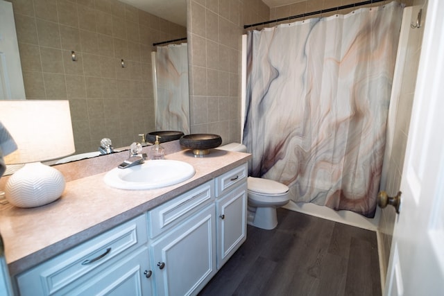 2 Labrador Ct, Columbus, GA 31909 - bathroom with vanity, wood finished floors, tile walls, a shower with curtain, and backsplash