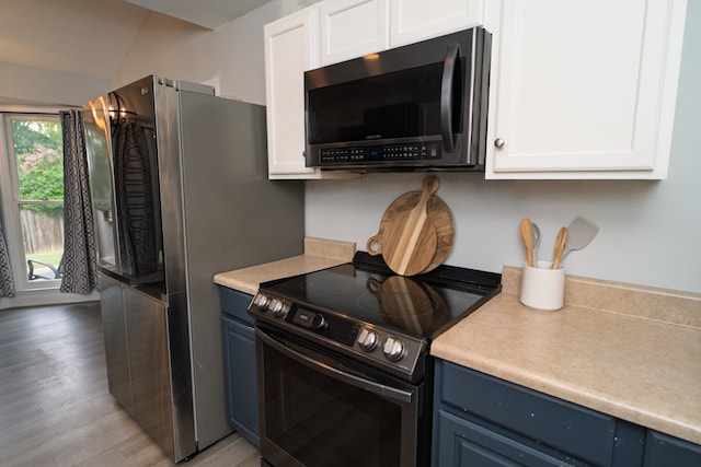 2 Labrador Ct, Columbus, GA 31909 - kitchen featuring electric range oven, blue cabinets, light countertops, white cabinets, and vaulted ceiling